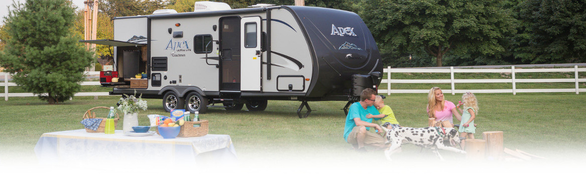Family outside of RV having a picnic