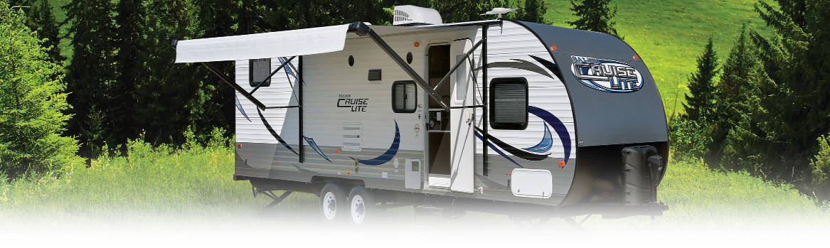 Cauise RV in front of trees
