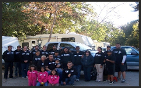 people posing outside of a RV